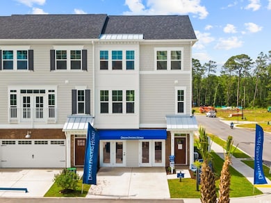 Townhome / multi-family property featuring a standing seam roof, concrete driveway, a metal roof, a garage, and roof with shingles