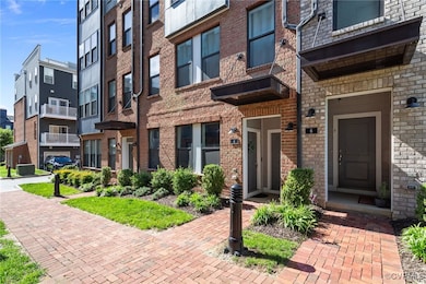 View of exterior entry featuring brick siding