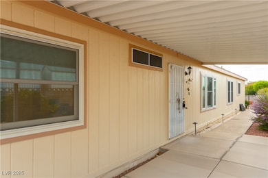 View of exterior entry with a covered patio