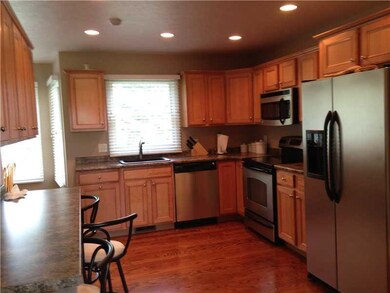 Kitchen. Maple cabinetry with bar area and SS appl