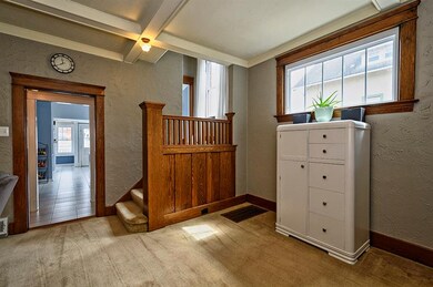 Over-sized entry boasts original wood work, coffer