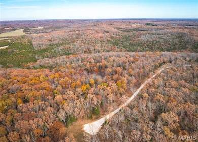 View of property location featuring a heavily wooded area