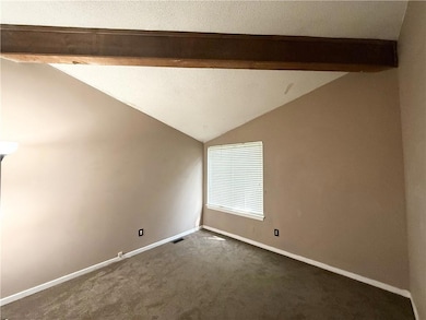 Unfurnished room featuring baseboards, lofted ceil