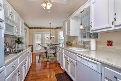 Upscale kitchen with solid surface counters and hardwoods. 