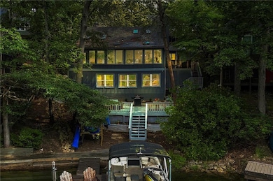 Rear view of house with a deck and stairs