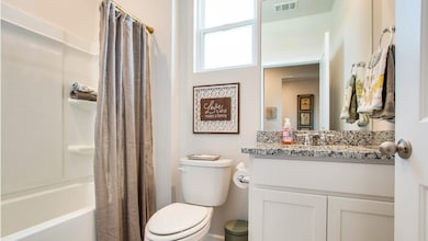 Bathroom featuring vanity and shower / bathtub combination with curtain