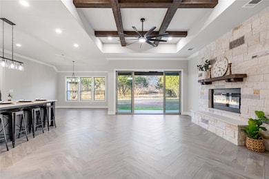 Living room with visible vents, baseboards, beame