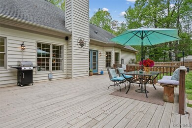 Wooden terrace featuring area for grilling