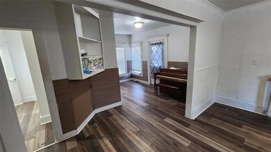 Foyer with dark hardwood / wood-style flooring