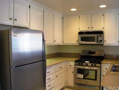 Kitchen with granite counters and newer stainless steel appliances.