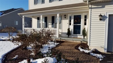 FULL PORCH ACROOS FRONT. PROFESSIONALLY LANDSCAPED AND BRICK WALKWAY