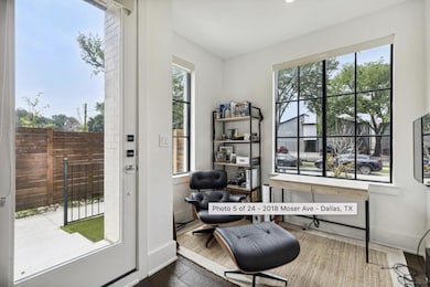Living area with a healthy amount of sunlight and dark hardwood / wood-style flooring