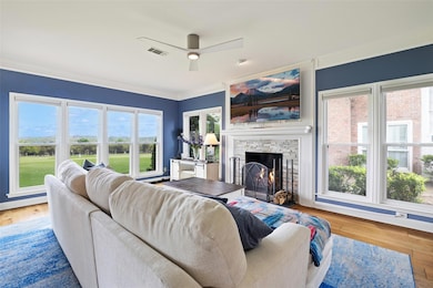 Living room with ornamental molding, visible vent