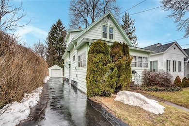 Private driveway with detached garage. Shrubbery p
