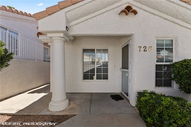 Property entrance featuring a tiled roof and stucco siding