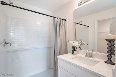 Bathroom featuring vanity and curtained shower