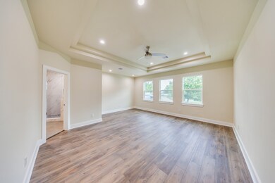 The oversized primary bedroom is a true retreat, f