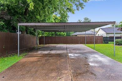 Extended driveway leading to detached covered with