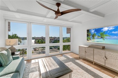 Sunroom featuring a water view, beam ceiling, and