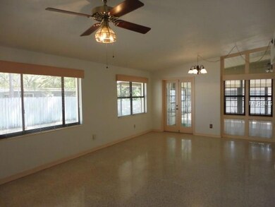 Living/Dining Combo with tons of windows and vaulted ceilings.  Polished terrazzo floors.