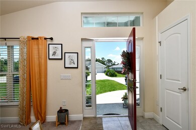 Tiled entrance foyer featuring lofted ceiling