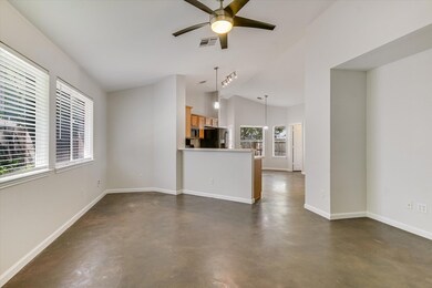 Unfurnished living room featuring concrete floors