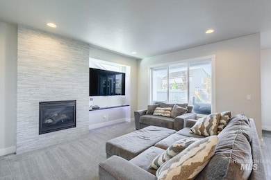 Carpeted living area featuring a fireplace and recessed lighting