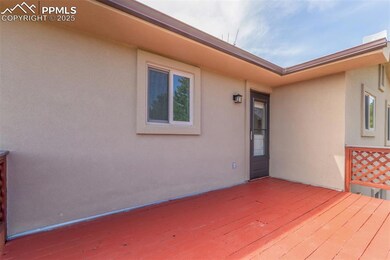 Large deck with entrance into the kitchen.