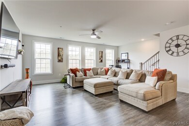 Living room featuring ceiling fan and hardwood / w
