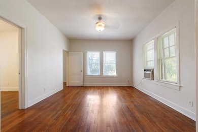 Empty room featuring dark wood finished floors an