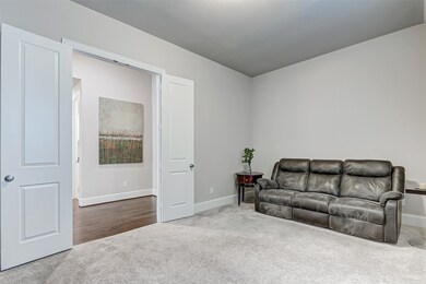 Entertainment room enclosed by double doors, whether you convene for movie night or utilize it as a game room, you are sure to have fun in this amazing space!