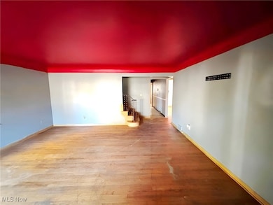 Living room featuring light wood-type flooring and stairs