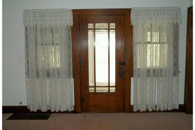 Living Room. Front door to porch.  Natural trim.