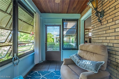 Unfurnished sunroom featuring wooden ceiling and plenty of natural light