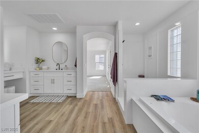 Full bath featuring vanity, a bath, wood finished