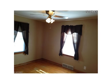 The front bedroom features, hardwood flooring, two