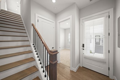 Just off the foyer is convenient access to the garage and first-floor bedroom with an ensuite bath.