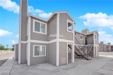 Back of house featuring a chimney and stairs