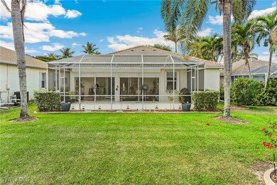 Rear view of house with a tiled roof, a lanai, stu