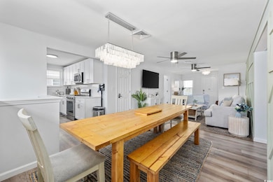 Dining room with visible vents, light wood-style f