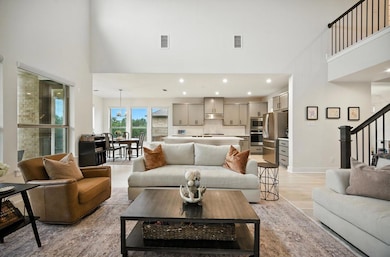 Living room with a high ceiling, light wood finis