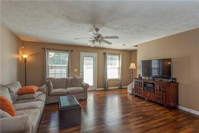 Entry hall way opens onto large living room that s