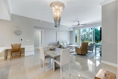 Dining area with crown molding, baseboards, a ceiling fan, and a chandelier