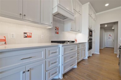 Kitchen with premium range hood, crown molding, li