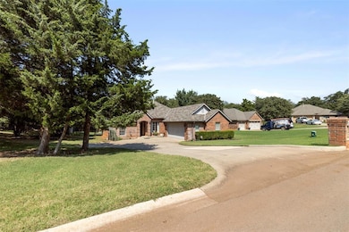 Ranch-style house featuring driveway, stone siding, a front yard, and an attached garage