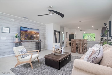 Living room featuring ceiling fan, sink, light til