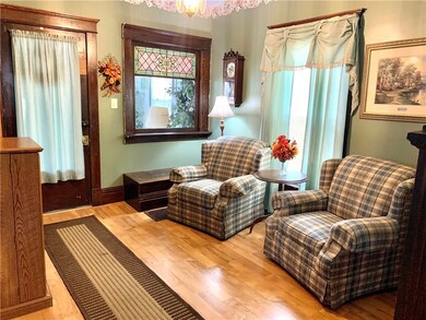 A parlor with an original stained glass window.