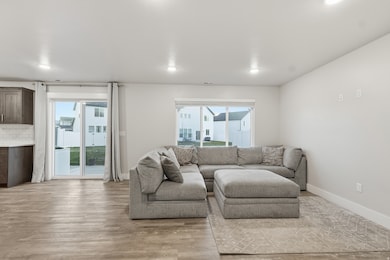 Living room with light wood-style floors and baseboards