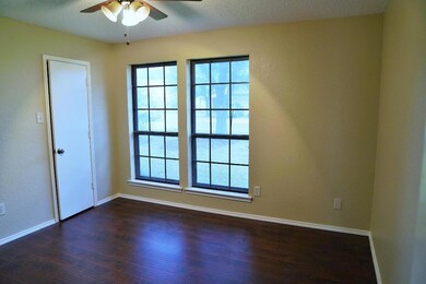 Empty room featuring hardwood / wood-style flooring, a healthy amount of sunlight, and ceiling fan