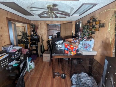 Dining room with ceiling fan, a textured ceiling, 